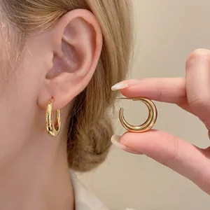 Polished chunky gold C-shaped hoop earrings for women with a minimalist metallic finish