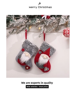 Detail of red and grey Christmas stockings with 3D gnomes and faux fur trim decorations
