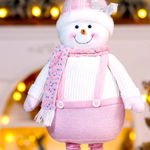 Detail of pink and white plush Christmas snowman with sequins in a cozy festive setting