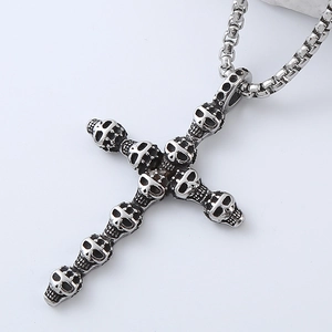 Macro detail of gothic skull cross pendant with oxidized silver finish on box chain