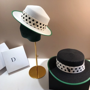 Flat top straw hat with green trim and polka dot ribbon featuring M metal buckle