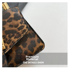 Detail of leopard print faux leather handbag with textured finish and gold metal buckle