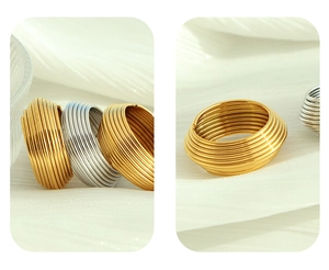 Detail of multi-layered spiral rings in gold and silver finish with striped texture