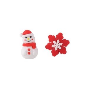 Macro shot of asymmetric Christmas earrings featuring a resin snowman and red snowflake