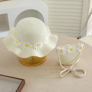 Detail of kids straw sun hat and bag set with 3D daisy embroidery and scalloped edges
