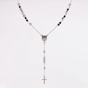 Macro detail of silver cube bead rosary necklace with Saint Benedict medal and cross