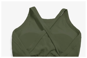 Detail of army green sports bra featuring criss-cross back straps and elastic hem