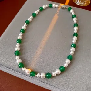 Vintage green agate and pearl beaded necklace with silver lobster clasp on velvet
