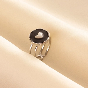 Macro detail of French retro silver heart ring on cream silk with oil pressure texture