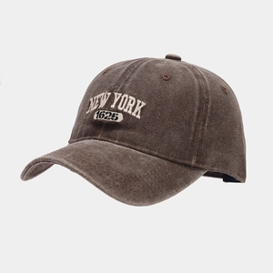 Detailed close-up of NEW YORK 1625 3D white embroidery on vintage brown baseball cap