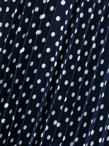 Detailed macro view of dark blue fabric with white polka dots and fine pleat texture