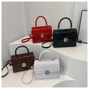 Detail showing stone pattern mini square bags in red, black, brown and white colors