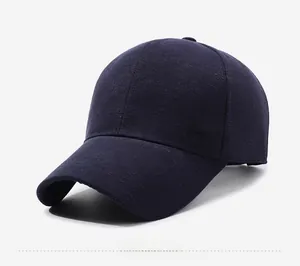 Side detail of a navy blue baseball cap featuring a silver metallic logo and textured fabric