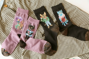 Detailed close-up of cotton socks with cat embroidery and sparkling gold details