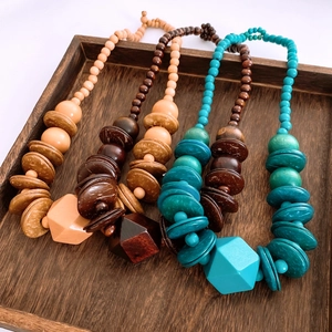 Detailed texture of bohemian wood beads and coconut shell geometric pendant necklaces