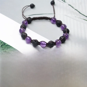 Detailed view of 8mm amethyst and black lava rock beaded bracelet with adjustable cord