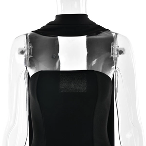 Detail of black backless tube dress with matching scarf on transparent mannequin