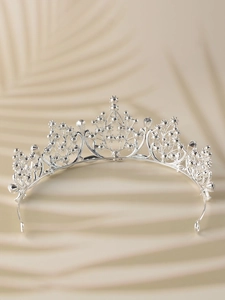 Detailed close-up of a silver alloy bridal crown with intricate hollow pattern and metal beads