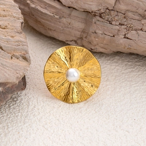 18K gold plated stainless steel ring with white pearl on a natural wood base