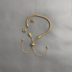 Detail of DIY golden snake chain bracelet with adjustable sliding beads and screw end