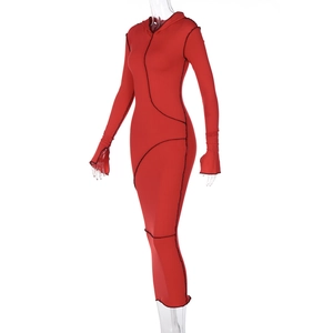 Detail of red hooded maxi dress featuring black contrast stitching and thumbhole cuffs