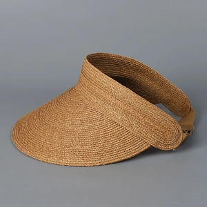 Macro detail of natural brown raffia weave with adjustable khaki strap and metal buckle