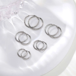 Minimalist silver stainless steel hoop earrings set in five different sizes for women