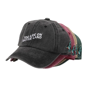 Washed cotton baseball cap with You Are On Native Land embroidery in four colors