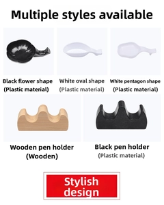 Macro display of assorted plastic ink dishes and wooden brush rests for calligraphy