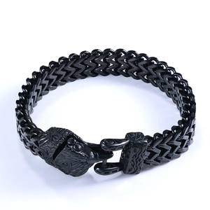 Detail of black stainless steel woven chain bracelet with animal head embossed clasp