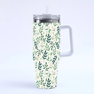 Close-up of the 40oz stainless steel tumbler with green leaf patterns and yellow berries