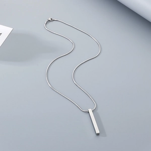 Sleek stainless steel rectangle pendant on a silver snake chain over grey background