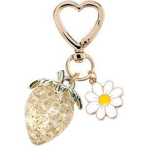 Detailed shot of golden heart clasp with glittery strawberry and daisy flower charms