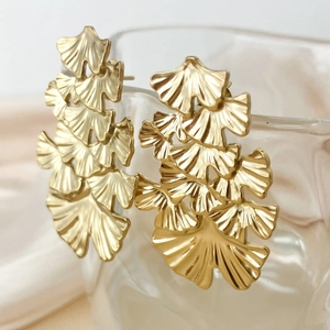 Elegant gold ginkgo leaf dangle earrings with layered matte finish on glass rim