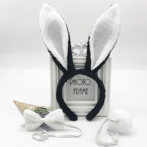 Detailed close-up of plush bunny ear headband, bow tie, and tail costume accessories set