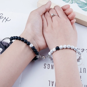 Close-up of magnetic natural stone bracelets for couples with black and white matte beads