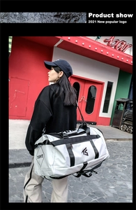 Close-up of white oxford travel bag with black straps and brand logo detail