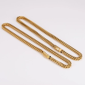 Close-up of dual gold wheat chains in stainless steel with durable lobster clasps