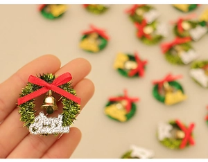 Detailed close-up of a miniature Christmas wreath with a red bow and a tiny gold bell