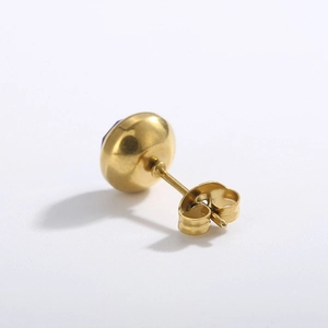 Detailed view of gold titanium steel stud earring featuring a dark blue zircon stone