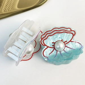 Chic shell-shaped hair claws in blue and white acrylic with pearl accent for women