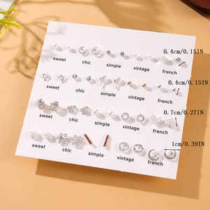 Set of 20 pairs minimalist earrings with pearls, hearts and stars on white card display
