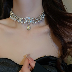 Detail of silver necklace with crystals and pearls featuring a waterdrop pendant