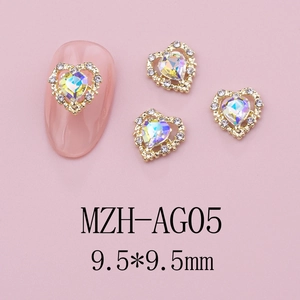 Close-up of 9.5mm aurora heart nail charms with golden hollow lace frames and rhinestones