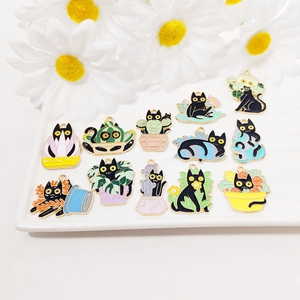 Detailed macro view of assorted enamel black cat and potted plant metal charms