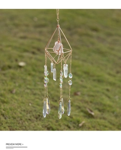 Detailed suncatcher with geometric gold frame and raw crystal stone in nature