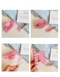 Detailed views of a pink resin shark hair claw and wing clip with rhinestone accents