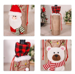 Detail of Christmas wine bottle covers featuring linen fabric with embroidery patterns