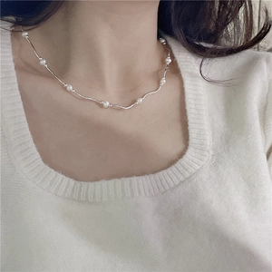 Elegant S925 silver wavy necklace with freshwater pearls shown on a female model