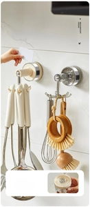 Close-up of the rotating six-claw storage hook mounted on a white tiled wall